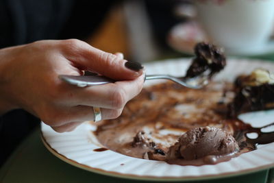 Cropped hand of woman eating ice cream