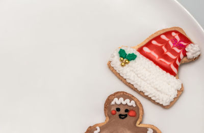High angle view of cookies in plate against white background