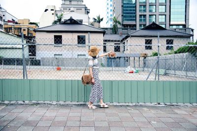 Woman walking by fence