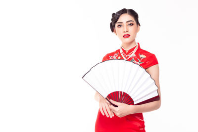 Portrait of young woman against white background