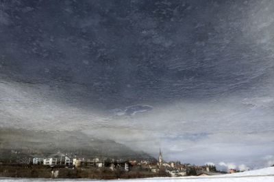View of houses against cloudy sky