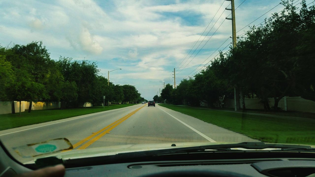 transportation, mode of transport, car, land vehicle, windshield, road, vehicle interior, car interior, tree, glass - material, transparent, travel, sky, on the move, road marking, car point of view, the way forward, cloud - sky, diminishing perspective, part of