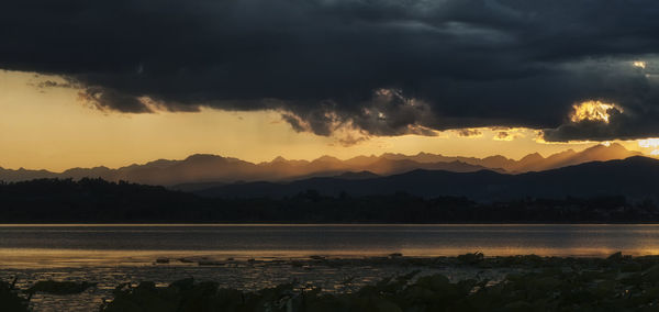 Scenic view of lake against sky during sunset