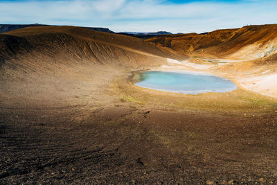 Scenic view of sand dunes against sky