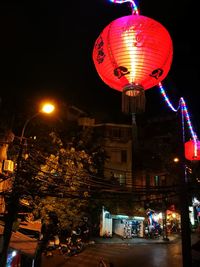 Illuminated lanterns in city at night