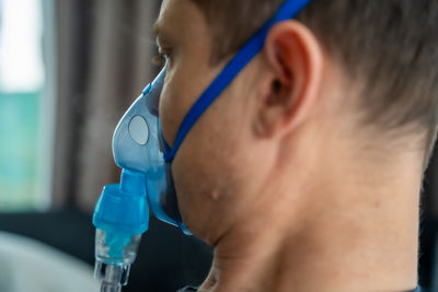 Close-up of young man drinking water