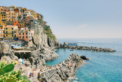 Panoramic view of sea and buildings against sky