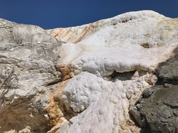 Low angle view of multi colored layers and formations at mammoth hot springs in yellowstone 