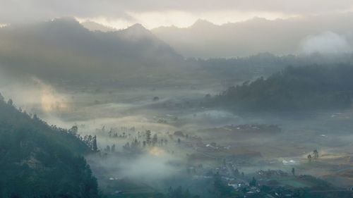 High angle view of trees and mountains against sky