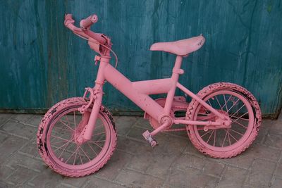 Pink bicycle on footpath
