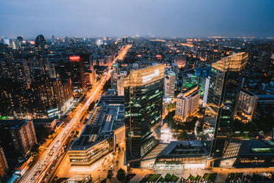 High angle view of illuminated city buildings against sky