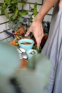 Midsection of man holding coffee cup