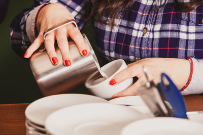 Midsection of woman holding coffee cup