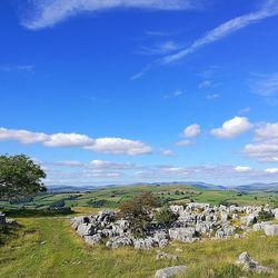 Scenic view of field against blue sky