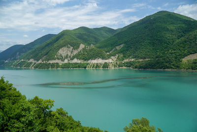 Scenic view of lake and mountains against sky