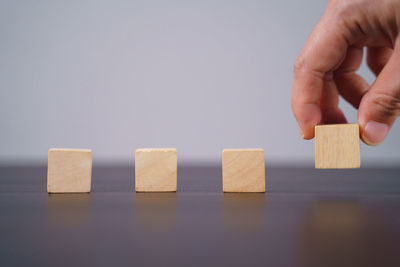 Cropped image of hand holding toy on table