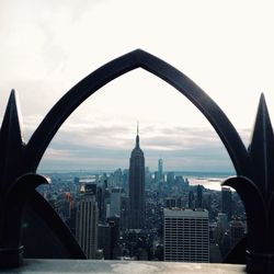 View of cityscape against cloudy sky