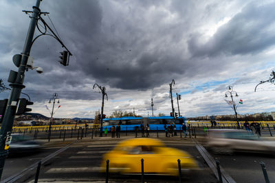 High angle view of city street against cloudy sky