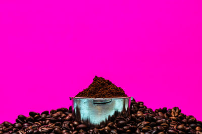 Close-up of coffee on table against pink background
