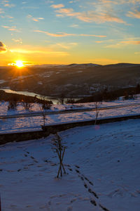 Scenic view of snowcapped mountains against sky during sunset