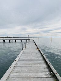 Pier over sea against sky