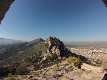 High angle view of buildings against clear blue sky