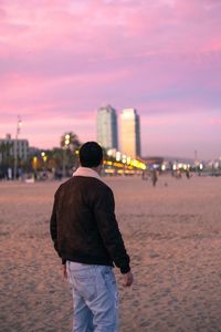 Rear view of man standing on beach