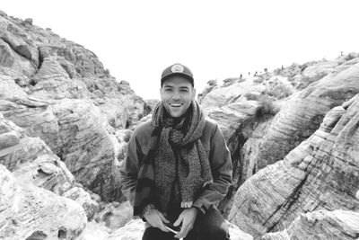 Portrait of young man standing on rock