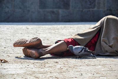 Midsection of man sleeping on street