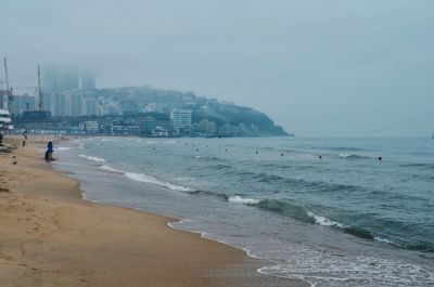 View of calm beach against clear sky