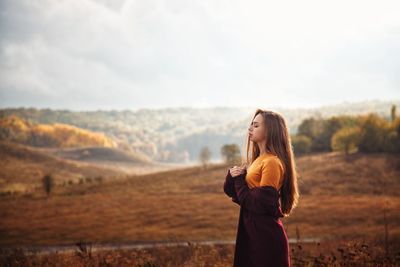 Woman standing on land against sky