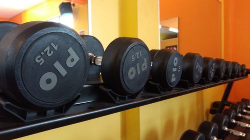 Close-up of dumbbells on shelf