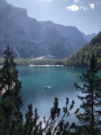 Scenic view of lake by mountains against sky