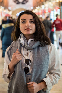 Portrait of woman holding a smiling while standing against blurred background