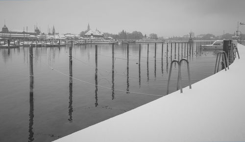 Pier over lake against clear sky