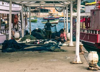 People working in boat at market