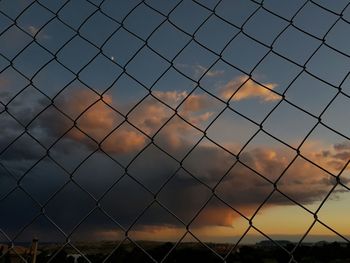 Full frame shot of chainlink fence against sky