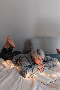 Boy lying on bed at home