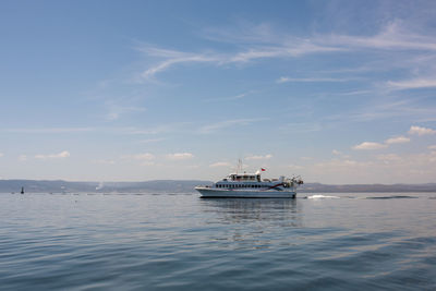 Ship sailing in sea against sky