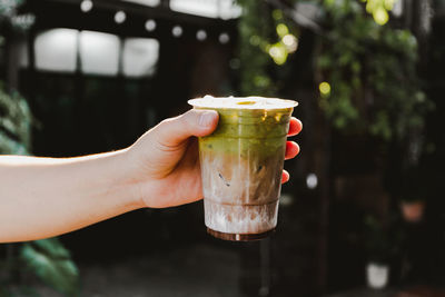 Close-up of hand holding smoothie