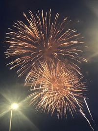 Low angle view of firework display at night