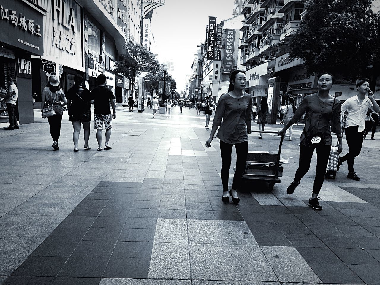 street, men, walking, city, building exterior, city life, person, lifestyles, transportation, large group of people, full length, city street, architecture, built structure, road, leisure activity, sidewalk, rear view, car