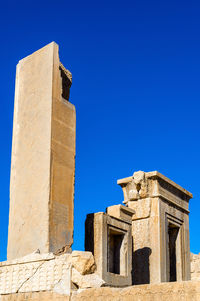 Low angle view of historical building against blue sky