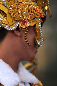 Side view of young man wearing headdress while standing outdoors