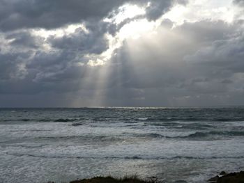 Scenic view of sea against cloudy sky