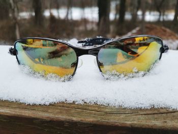 Close-up of sunglasses on snow