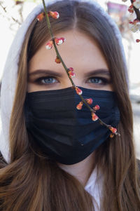 Close-up portrait of young woman wearing mask