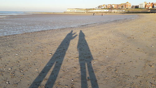 Shadow of sand on beach against sky