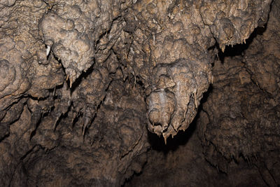 Close-up of rock formation in cave, stalactites in cave