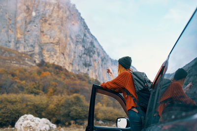 Rear view of man on mountain road against sky